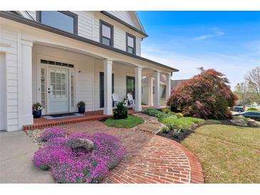 Charming front yard with a brick walkway leading to the inviting front porch and beautifully landscaped garden at 541 Lombard St, Marietta, GA 30064