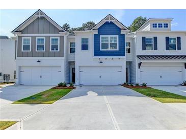 Charming townhouse exteriors featuring attached garages, painted brick, and various stylish color accents at 2674 Ne Almand Ne Ln, Conyers, GA 30013