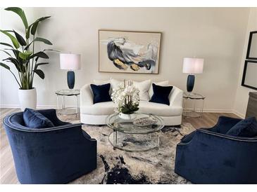 Bright living room features a modern white couch, contemporary art, and stylish decor at 2674 Ne Almand Ne Ln, Conyers, GA 30013