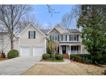 Charming two-story home features stone accents, a covered porch, and a two-car garage at 1810 Valley Brook Dr, Alpharetta, GA 30005
