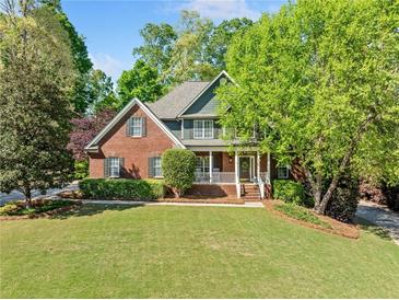 Charming brick home featuring manicured landscaping and a welcoming front porch at 204 Overland Trl, Mcdonough, GA 30252