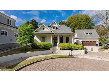 Charming home with landscaped front yard, welcoming porch, and detached garage providing great curb appeal at 216 Haralson Ne Ln, Atlanta, GA 30307