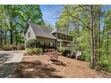 Charming two-story home with a well-manicured front yard and a welcoming front porch at 5876 Bridgemont Nw Pl, Acworth, GA 30101