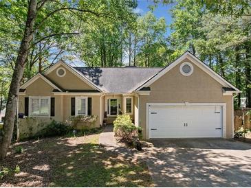 Charming one-story home featuring a two-car garage and a well-maintained front yard at 614 Springharbor Dr, Woodstock, GA 30188