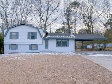 Charming two-story home featuring a carport and freshly painted exterior with lovely trim at 2637 Sol Ct, Ellenwood, GA 30294