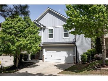 Charming two-story home with a two-car garage and well-manicured landscaping at 542 Broughton Dr, Canton, GA 30114