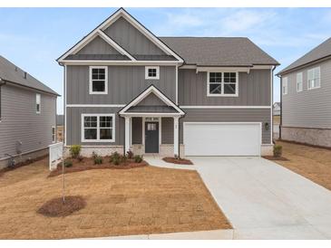 Charming gray two-story home with white trim, an attached garage, and a well-manicured front yard at 131 Hampton Ter, Dallas, GA 30157