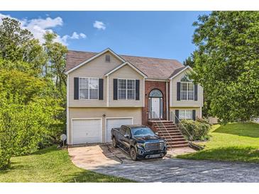 Traditional two-story home with a well-maintained front yard and attached two-car garage at 7450 Chads Cir, Jonesboro, GA 30236