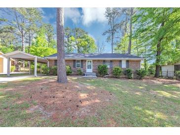 Charming one-story brick home with a well-maintained lawn and covered carport at 190 Sunrise Cir, Riverdale, GA 30274