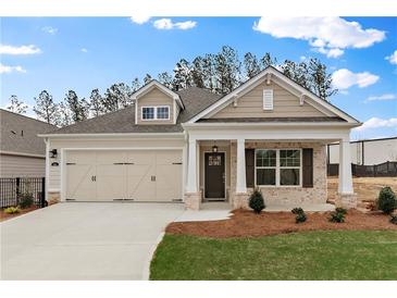 Charming single-Gathering home with a well-manicured lawn, two-car garage, and a welcoming front porch at 1216 Cedarcrest Blvd, Acworth, GA 30101