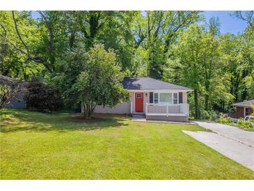 Charming brick bungalow with a red door, front porch, and a well-maintained lawn surrounded by mature trees at 2041 W Flat Shoals Ter, Decatur, GA 30034