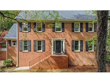 Charming brick home with black shutters and a well-maintained front yard at 297 Breeze Hill Ln, Canton, GA 30114
