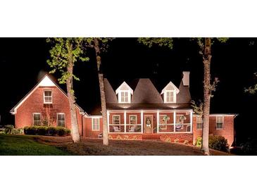 Charming brick home at night featuring a welcoming front porch with decorative wreaths at 125 Abner Dr, Mcdonough, GA 30252