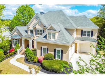 Stunning two-story home boasting a manicured lawn, beautiful landscaping and a charming covered entryway at 3233 Bagley Psge, Duluth, GA 30097