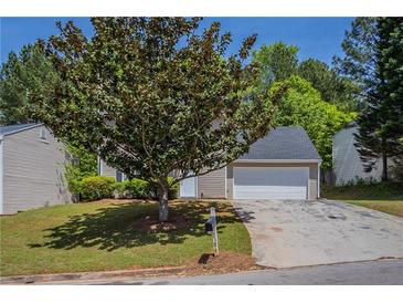 Charming single-Gathering home featuring an attached garage and well-maintained front lawn at 2386 Mills Bnd, Decatur, GA 30034