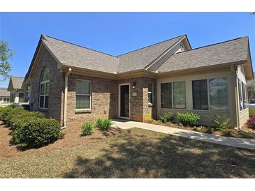 Charming brick home featuring a well-manicured lawn and an inviting front entrance at 102 Silver Summit Se Dr, Conyers, GA 30094