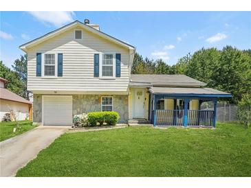 Charming two-story home with a well-maintained lawn, stone accents, and a covered front porch at 1248 To Lani Ct, Stone Mountain, GA 30083