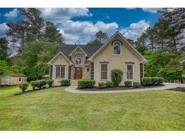 Charming home with stone accents, manicured lawn and mature trees at 1761 Mcdaniel Mill Rd Sw, Conyers, GA 30094