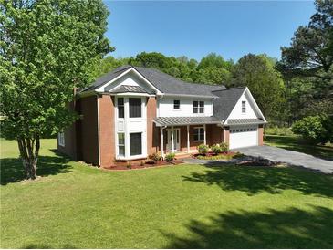 Beautiful two-story home with a well-manicured lawn, brick accents, and a charming front entrance at 2156 Fairway Cir, Duluth, GA 30096