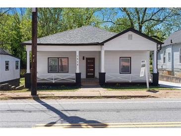 Charming renovated home featuring classic design with modern colors, a porch, and landscaped front yard at 1515 Jonesboro Rd, Atlanta, GA 30315