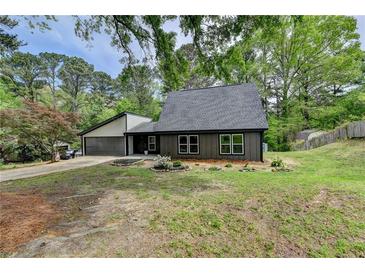 Charming home featuring a two-car garage and complemented by landscaping, offering both convenience and curb appeal at 226 Sandra Nw Dr, Lilburn, GA 30047