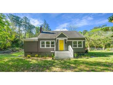 Charming single-Gathering home with a well-maintained lawn and a bright yellow front door at 3460 Old Fairburn Rd, South Fulton, GA 30349