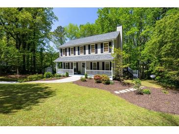 Charming two-story home with inviting front porch and landscaped front yard at 6005 Cherecobb Ln, Woodstock, GA 30188