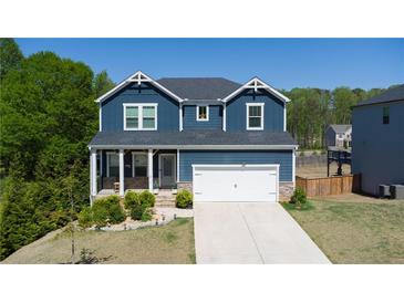 Beautiful two-story home featuring a well-manicured lawn and a two-car garage at 3690 Summerpoint Xing, Cumming, GA 30028