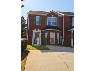 Charming brick home features a well-maintained yard and a cozy entrance at 5897 Strathmoor Manor Cir, Lithonia, GA 30058
