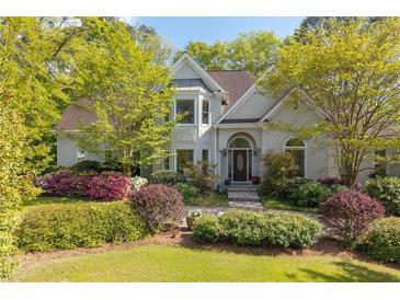 Charming traditional home featuring a manicured lawn and mature landscaping at 350 Covered Bridge Sw Pl, Smyrna, GA 30082