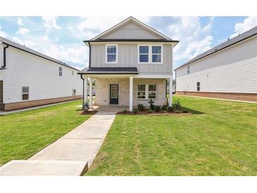 Charming two-story home with well-manicured lawn and inviting front porch and walkway at 1280 Firefly Field Trce, Lawrenceville, GA 30045