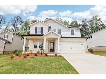 Charming two-story home with a brick facade, manicured lawn, and a two-car garage, offering curb appeal at 241 Martin Spring Rd, Lawrenceville, GA 30045