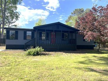 Charming home featuring a quaint front porch and freshly painted exterior, nestled in a sunny lot at 106 Evergreen Trl, Cartersville, GA 30121