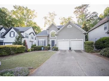 Charming two-story home with landscaped front yard and a two-car garage at 2019 Chelton Se Way, Smyrna, GA 30080