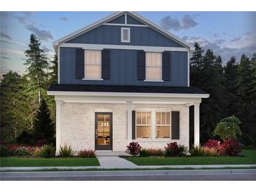 Charming two-story home with a brick facade, blue siding, black shutters, and a well-manicured lawn at 4680 Hemingway Trl, Cumming, GA 30041