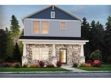 Charming two-story home featuring stone accents, a covered front porch, and a well-manicured lawn at 4690 Hemingway Trl, Cumming, GA 30041