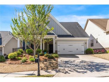 Charming two-story home featuring a two-car garage and beautifully landscaped front yard at 408 Windy Ridge Way, Canton, GA 30114