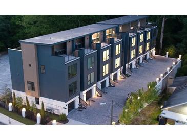 Stunning modern townhome exterior featuring a rooftop terrace and private garage at 1570 Flat Shoals Se Rd # 7, Atlanta, GA 30316
