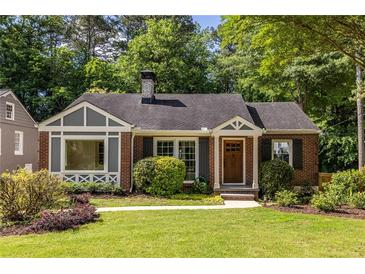 Charming brick home featuring a well-manicured lawn, complemented by lush greenery and a welcoming entrance at 333 Mimosa Dr, Decatur, GA 30030