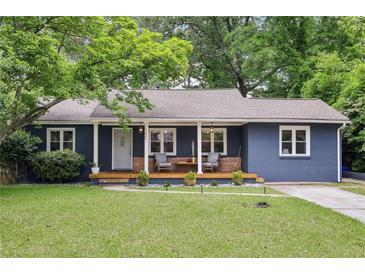 Charming blue painted brick home featuring a covered porch and a well manicured lawn at 1222 Crestwood Se Dr, Atlanta, GA 30316