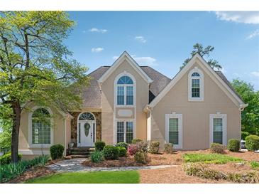 Charming two-story home featuring a beautifully landscaped yard and a welcoming front entrance with stone accents at 2849 Shiaway Trl, Snellville, GA 30039