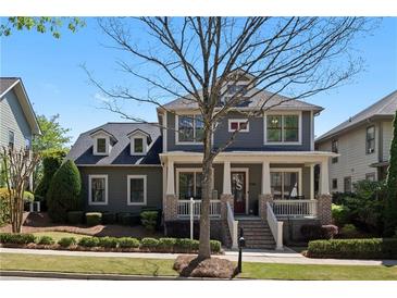 Charming two-story home featuring a welcoming front porch and beautiful landscaping at 9988 Devonshire St, Douglasville, GA 30135