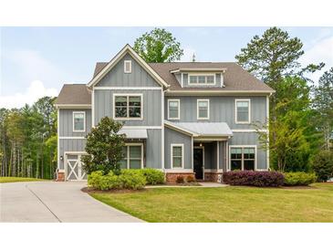 Charming two-story home with gray siding, manicured lawn, and inviting curb appeal at 4496 Sardis Church Rd, Buford, GA 30519