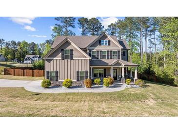 Beautiful two-story home with a landscaped front yard, showcasing its charming curb appeal and inviting entrance at 6062 Fielder Way, Douglasville, GA 30135