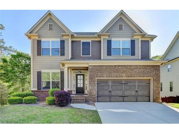 Charming two-story home featuring a well-manicured lawn and a brick-accented facade at 2272 Misty Brook Ct, Buford, GA 30519