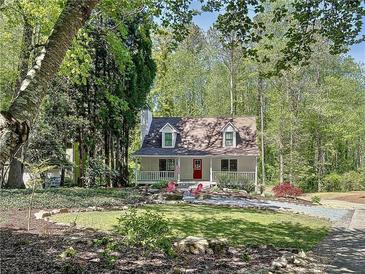 Charming two-story home with a landscaped yard and welcoming front porch and a fire pit at 1004 Westminister Ct, Woodstock, GA 30188