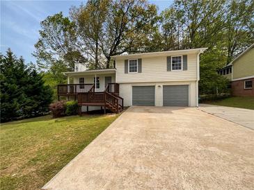 Charming two-story home with a deck, two-car garage, and a spacious driveway at 2390 Century Ln, Snellville, GA 30039