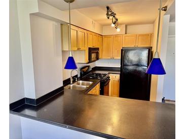A well-lit kitchen features stainless steel appliances and sleek countertops at 2479 Ne Peachtree Ne Rd # 1112, Atlanta, GA 30305