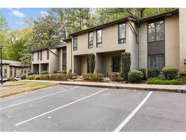 Two-story condo with well-maintained landscaping and ample parking spaces at 72 Ivy Ne Pkwy, Atlanta, GA 30342