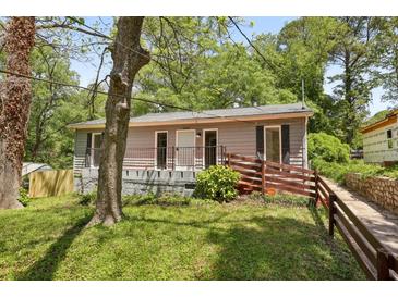Charming single-story home with a cozy front porch and well-maintained landscaping at 1545 Orlando Sw St, Atlanta, GA 30311